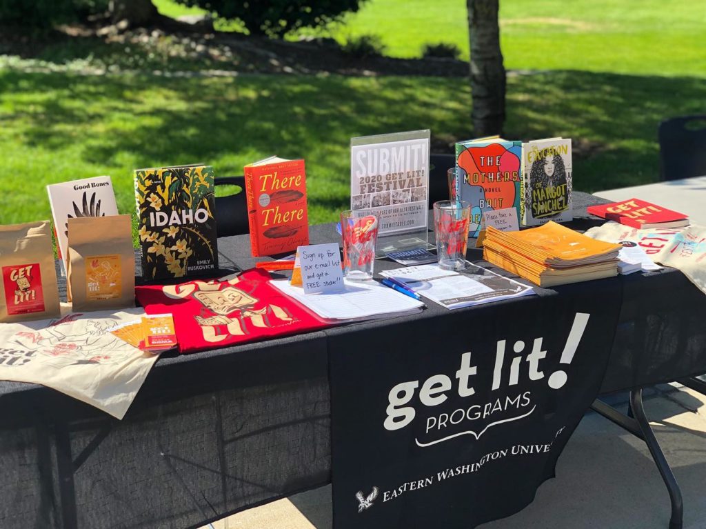 A photo of books and Get Lit merchandise on a table in Spokane's Eastern Washington University campus