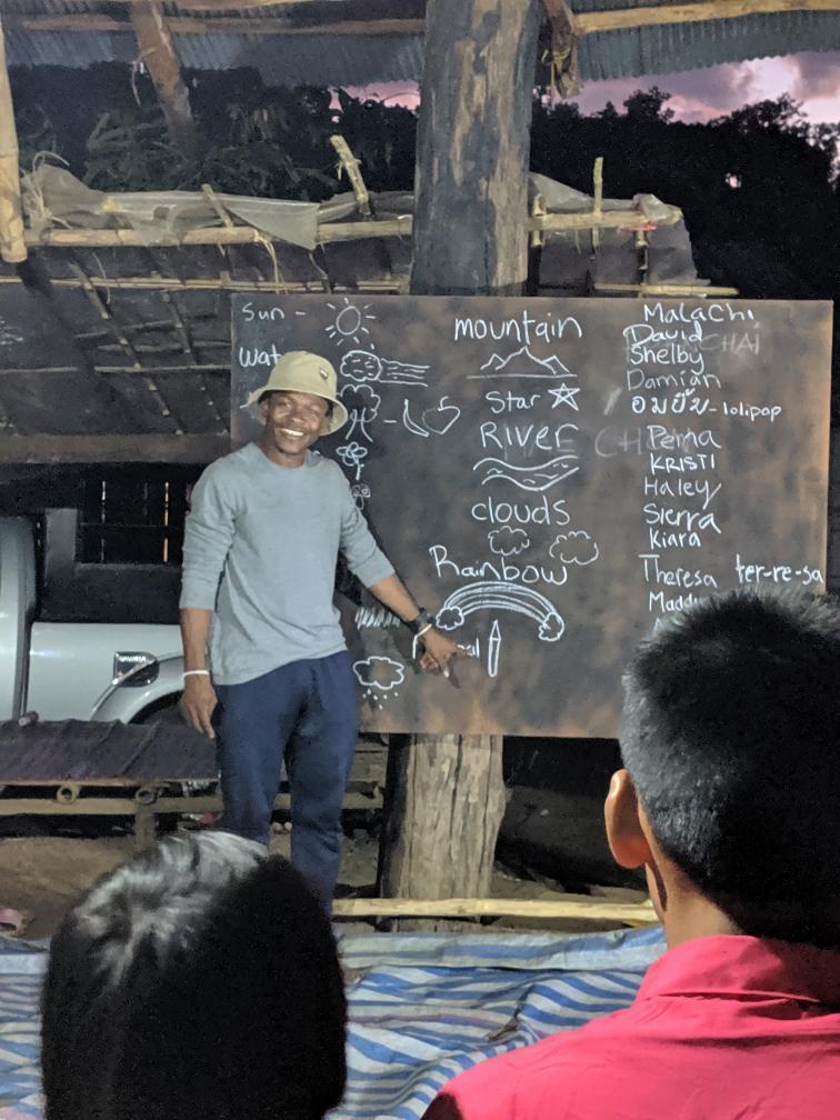 Malachi Chukwu teaches spelling to children in Palong Tribe