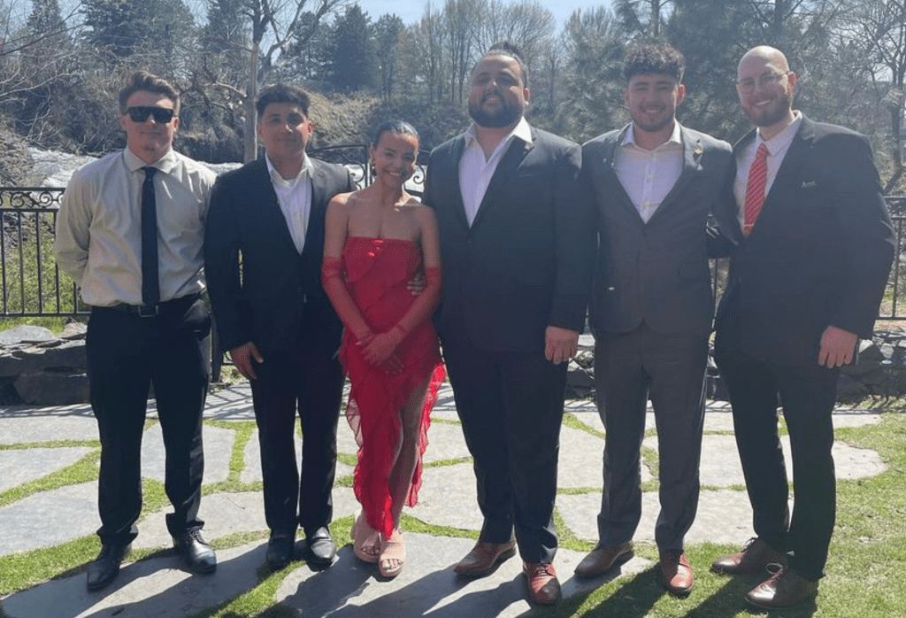Group of fraternity students in formal wear with their fraternity's sweetheart