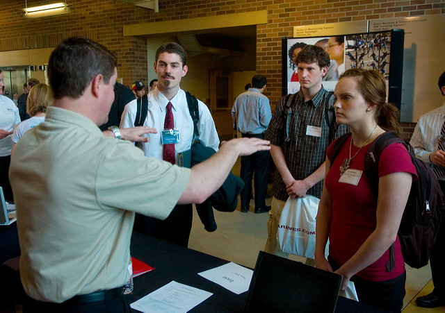photo of students conversing There is a man and woman talking in front of two other men
