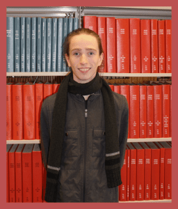 photo of oran bordwell in front of bookshelves